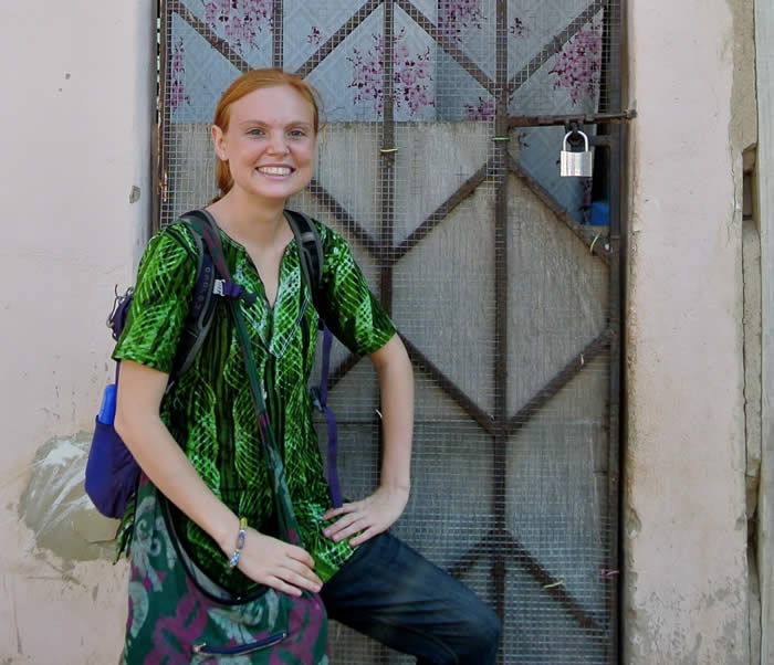 Student standing outside a doorway