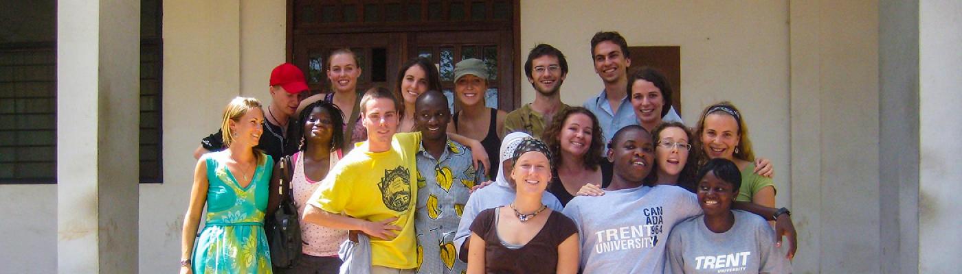 A group of International Development Studies students gathered on the front steps of a building in Ghana
