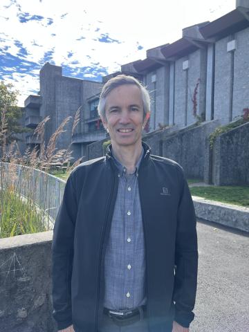 Professor standing in front of Champlain college campus