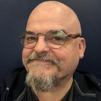 person with pale skin, bald, glasses, goatee