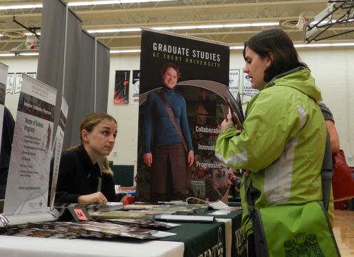 Erin Davidson provides information to graduate student at the Grad Expo