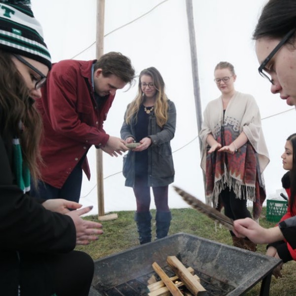 Students around a ceremonial fire