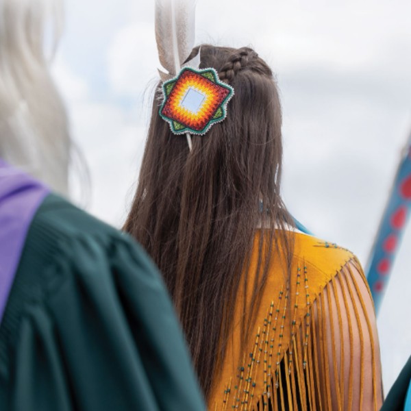 A student in traditional regalia at convocation