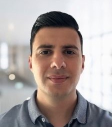 Man with dark short hair looking pensive