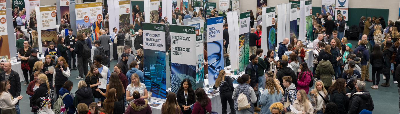 Large group of people in an event space with booths