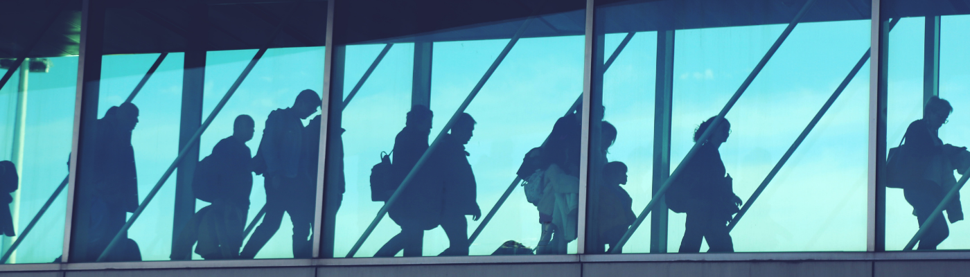 A group of people walking through an airport