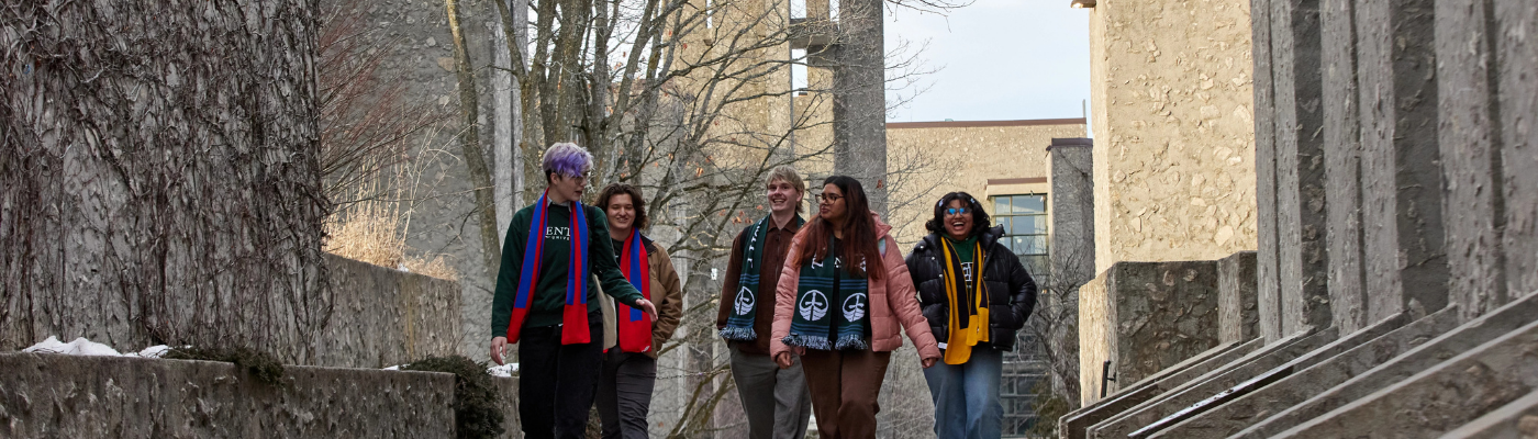 A group of students walking through a stone walkway