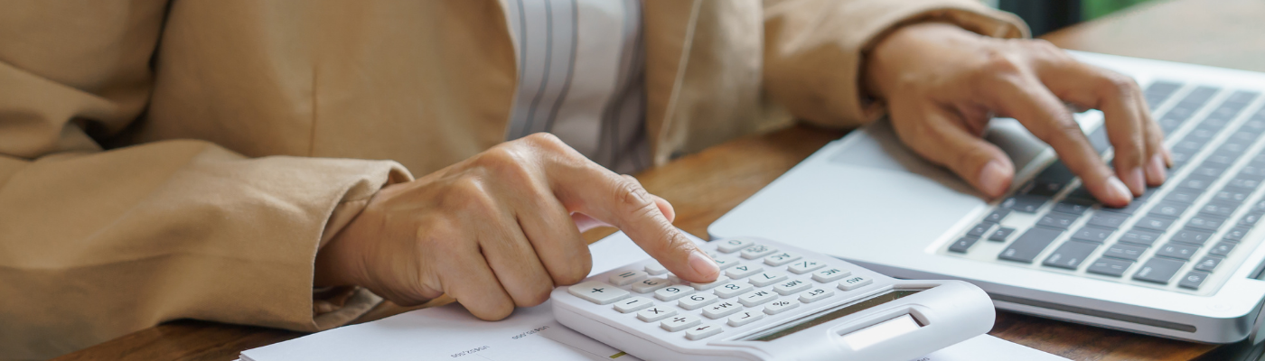 Person typing into a calculator