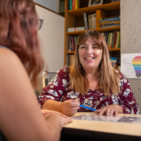 Academic Advisor speaking with student in an office