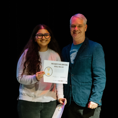 Student receiving an award from a professor