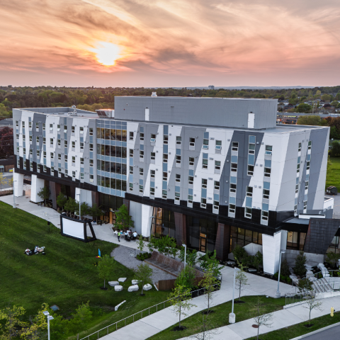 Academic building with an orange sunset behind it