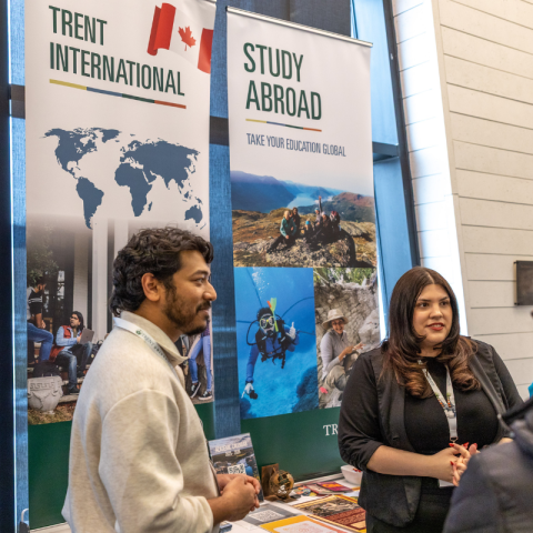 Two Trent International staff standing at an event booth