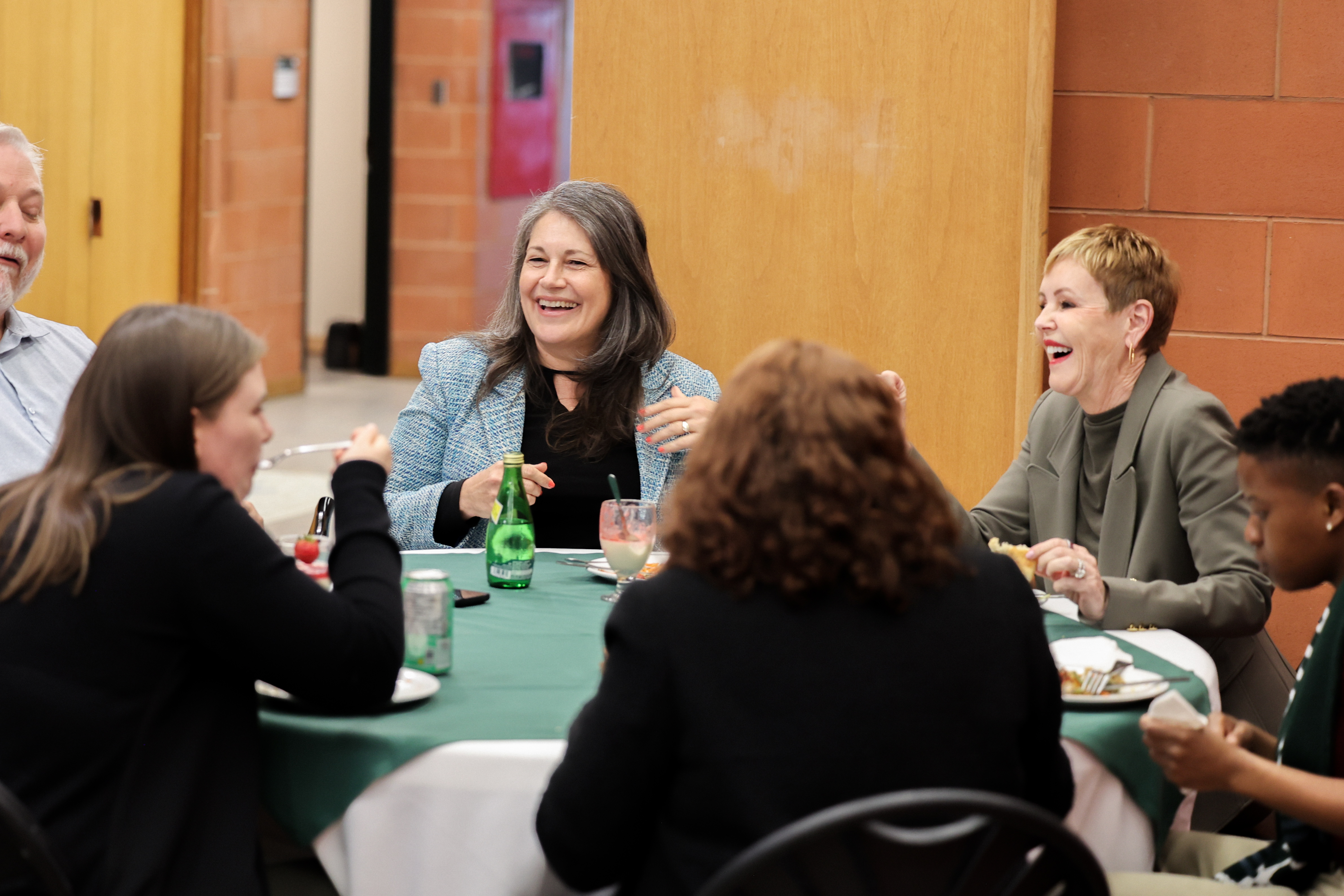 Julie talking at a table