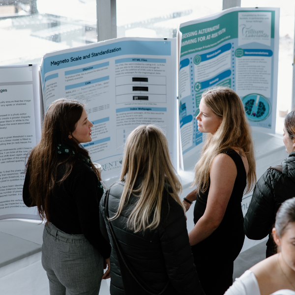 Students talking about research with project boards