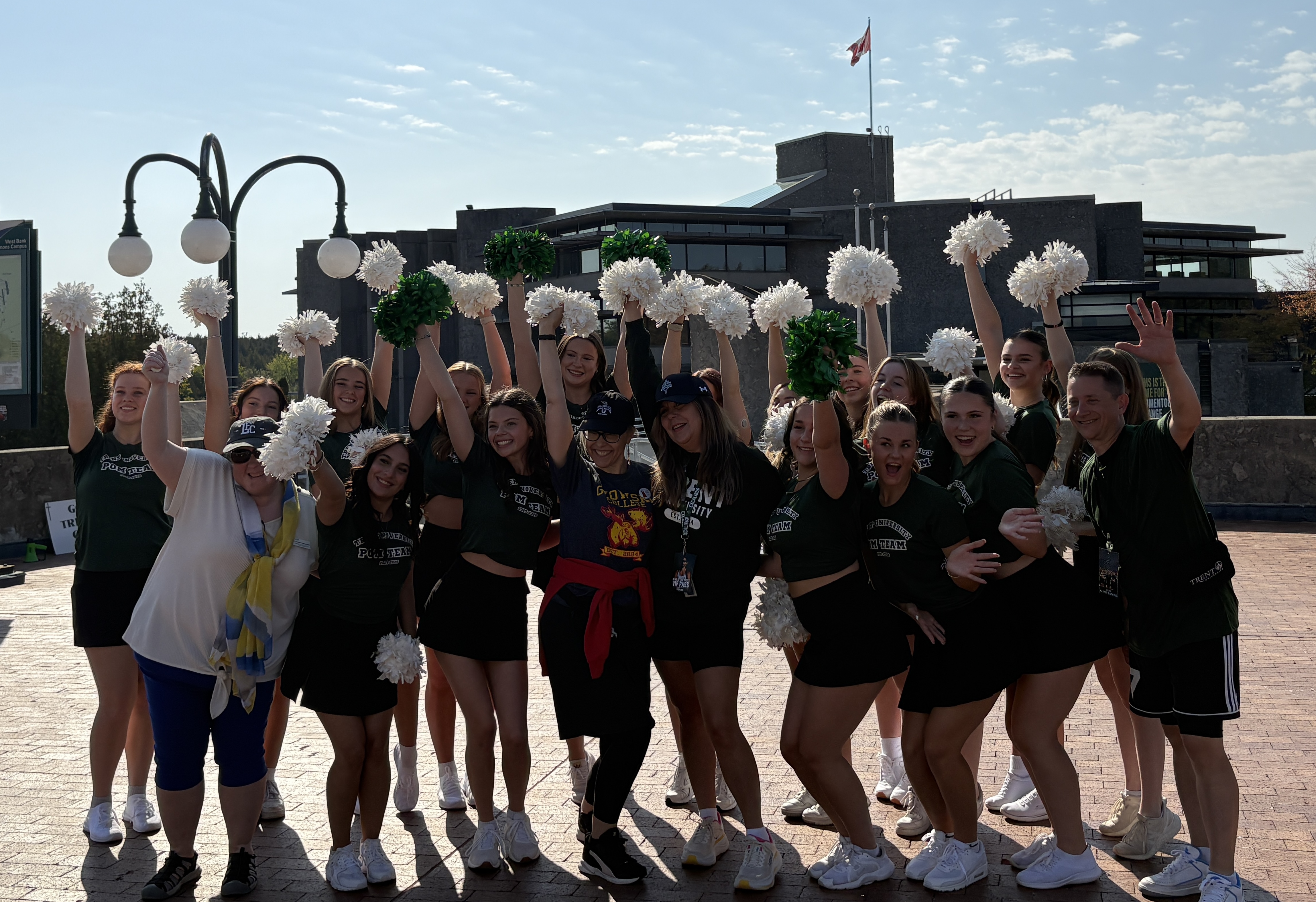 Stephanie cheers with students on the bridge