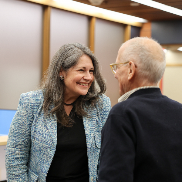 Julie Davis talking with board member