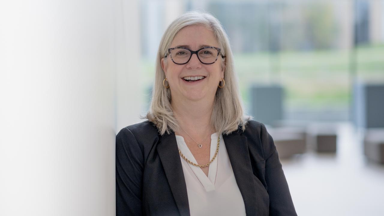 Dr. Tana J. Allen leans on a white post
