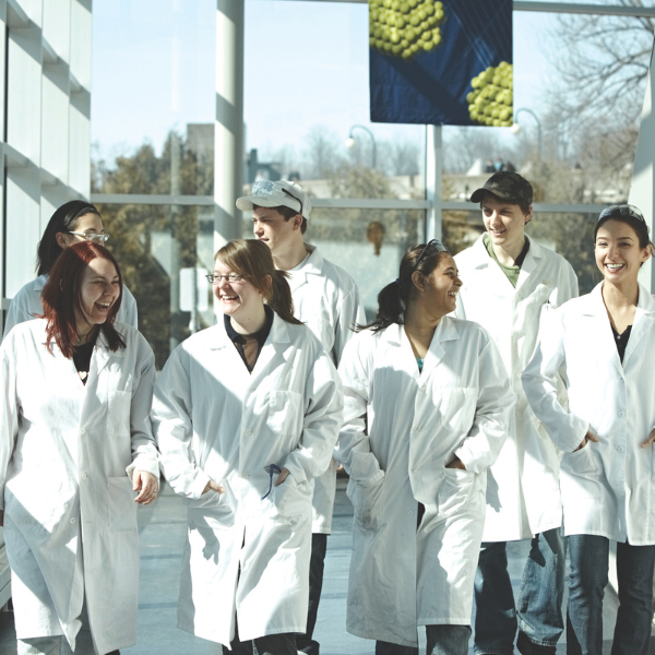 Students walking in lab coats