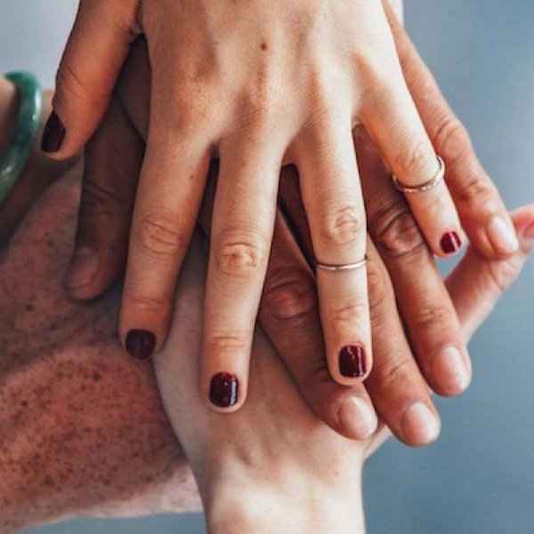 Hands piled on one another