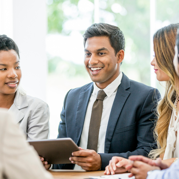 People talking at a board room desk