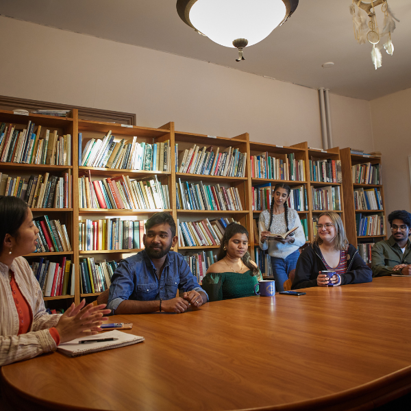 People talk at a board room table
