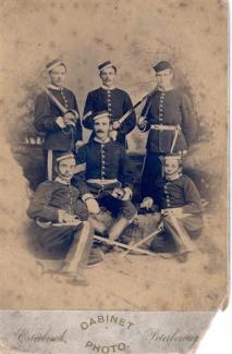 A portrait photograph of 6 men in uniforms holding swords. The bottom of the photograph says Cabinet Photo, Esterbrook, Peterborough