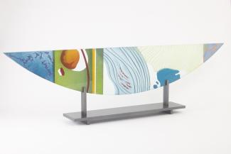 Semi-circle glass sculpture with abstract design.