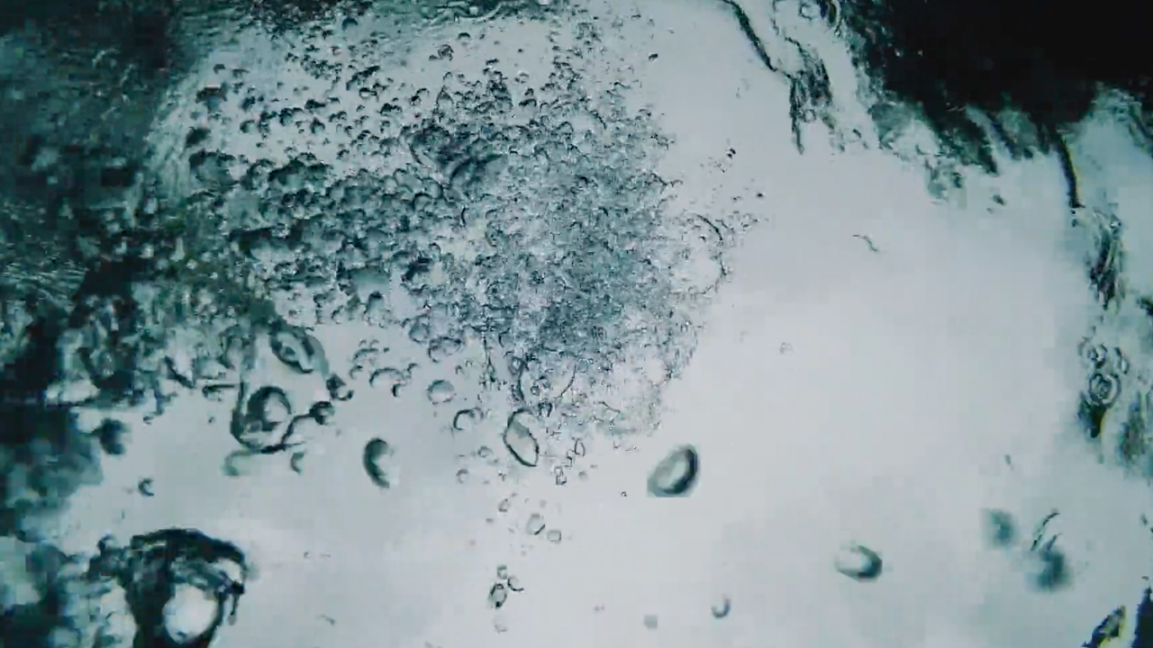 Bubbles running through water.