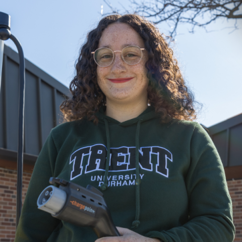 Jade Gauthie holding EV plug