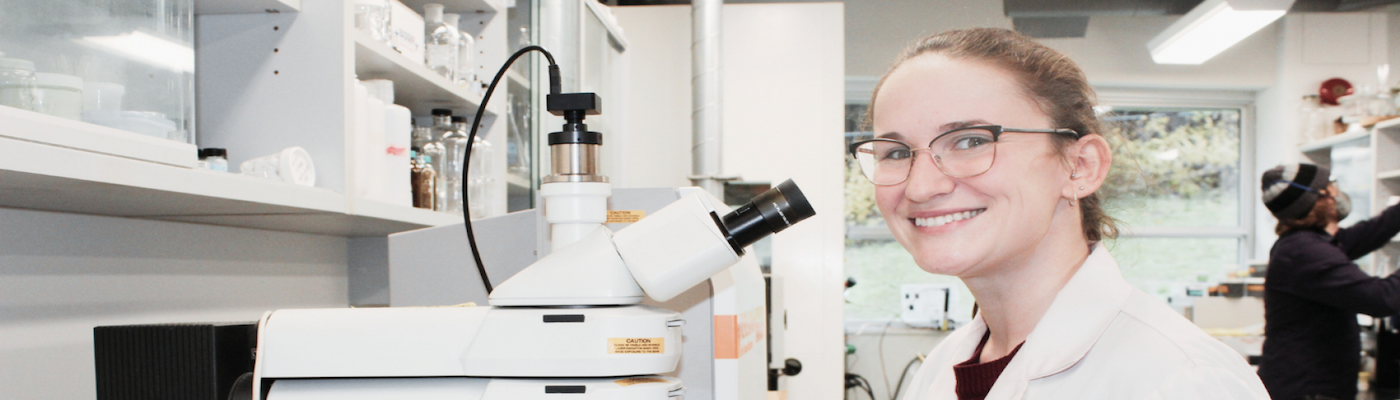 materials science student, Sara, smiling at camera in lab