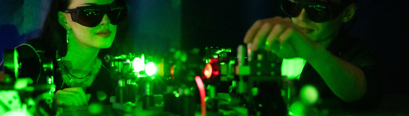 dr bradac's lab upclose lasers with 2 students