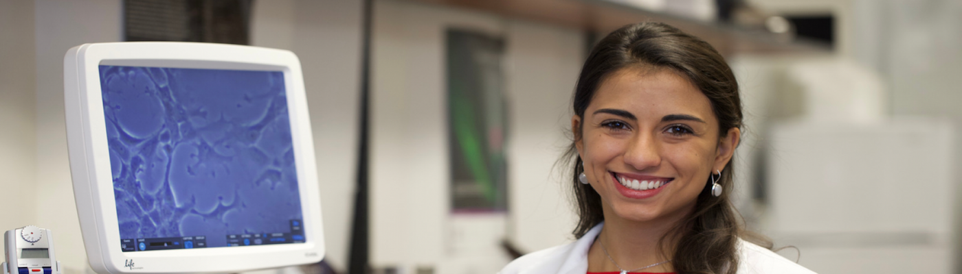women in lab smiling at camera