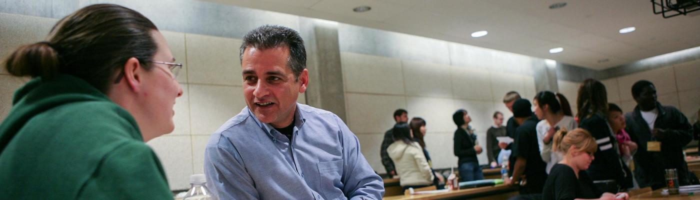 photo of professor in lab helping student