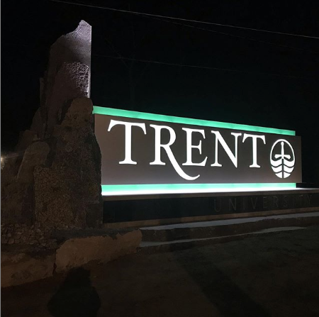 The new Trent University west bank sign lit up at night