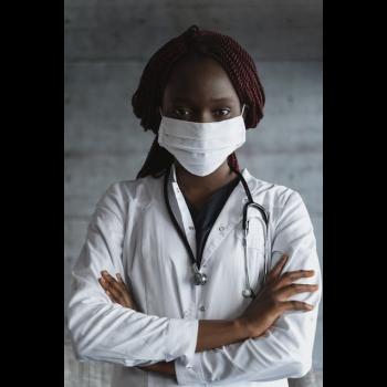 Close-up photo of nurse with mask.