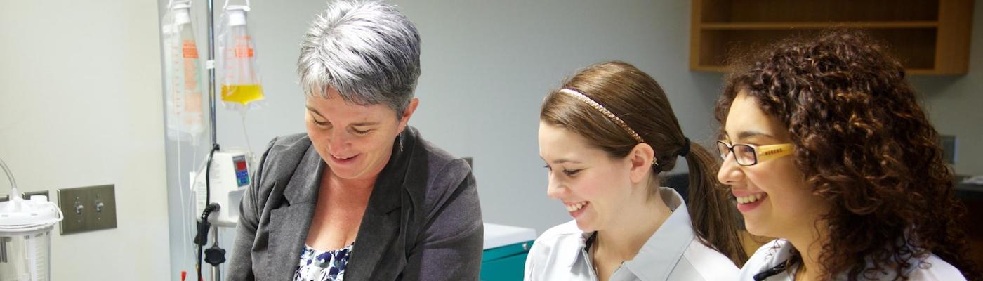 Three nursing instructors/students in a nursing lab