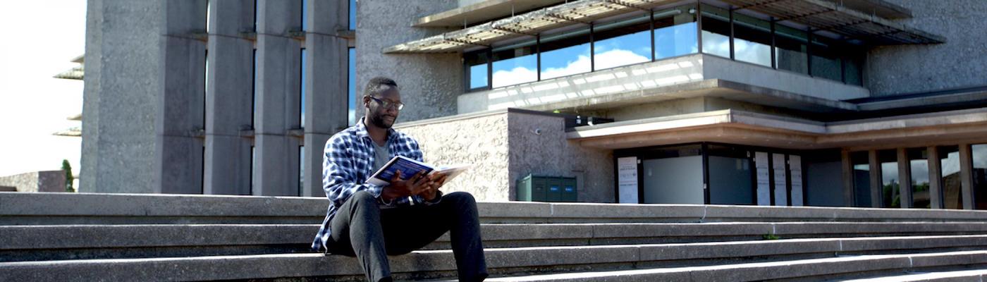 Trent student studying at Bata Library steps 