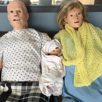 Three high fidelity Mannequins. from left to right, adult make mannequin, Hal, baby mannequin, Trent, and adult female mannequin Noelle. 