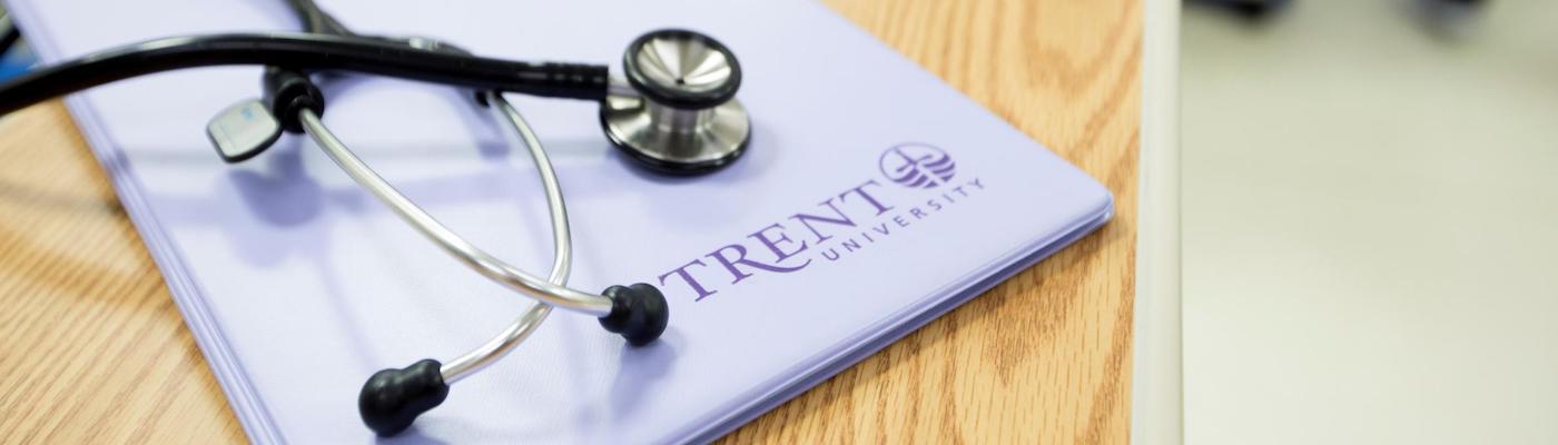 Stethoscope on a file folder on a desk