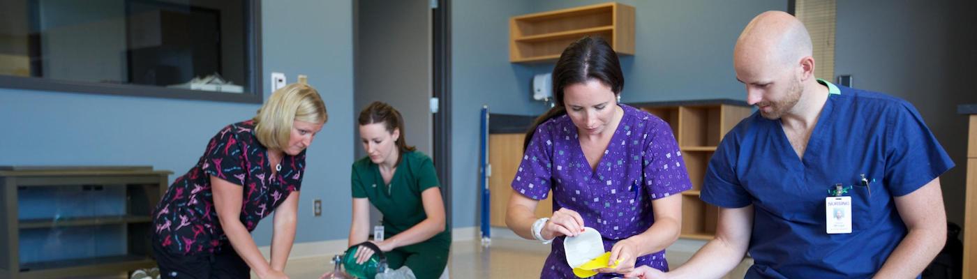Four nursing staff in scrubs