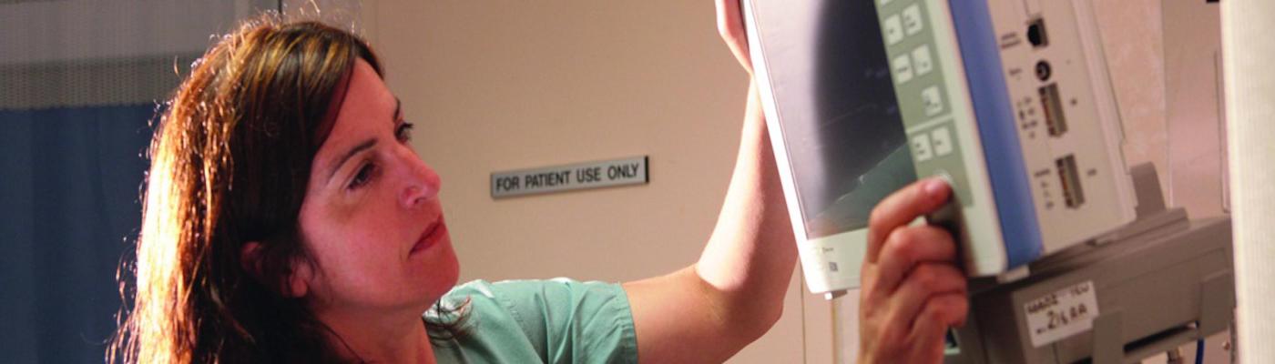 Nurse adjusting IV machine