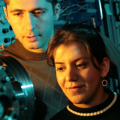 Two researchers studying a machine