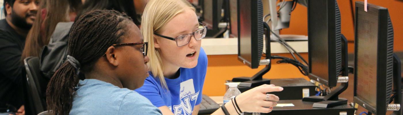 Two researchers working at a computer