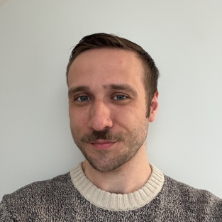 Benjamin Dafoe smiling against a white background