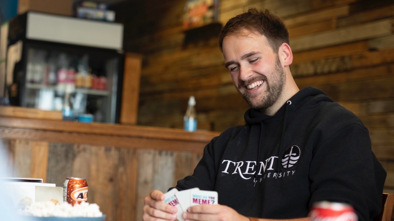 A student playing cards in a cafe