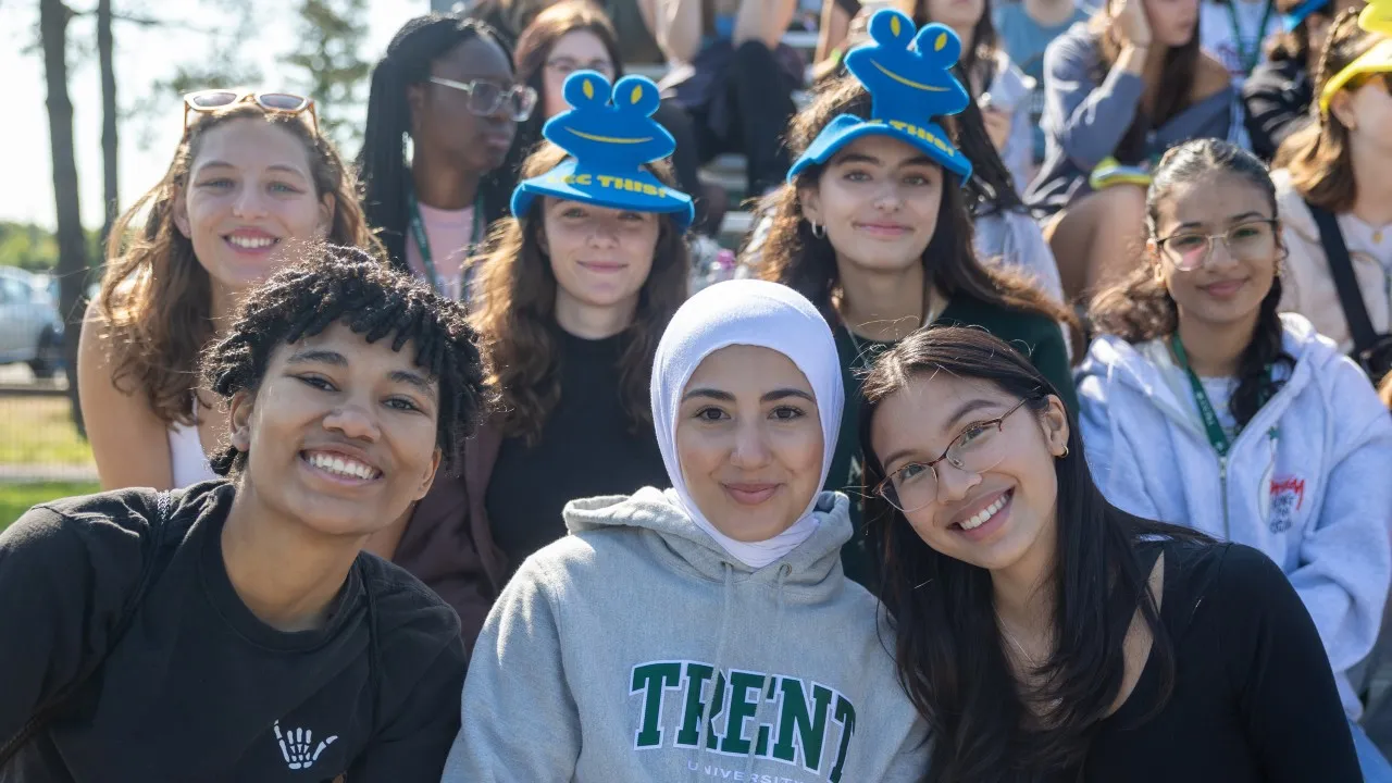 Students gathering and facing camera smiling
