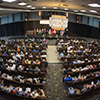 Birds eye view of the Ajax Convention Centre with audience sitting in seats watching the ceremony on stage