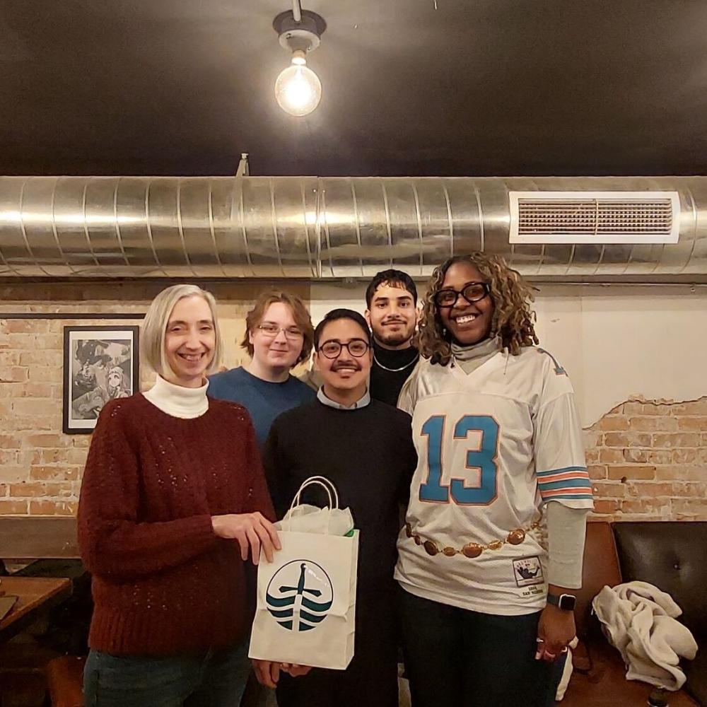 a group of students and professor looking into the camera and smile