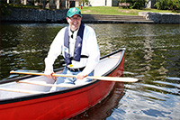 Dr. Franklin in a canoe on the Otonabee river in the summertime