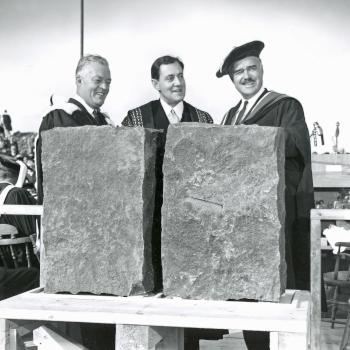 THB Symons standing with two colleagues.